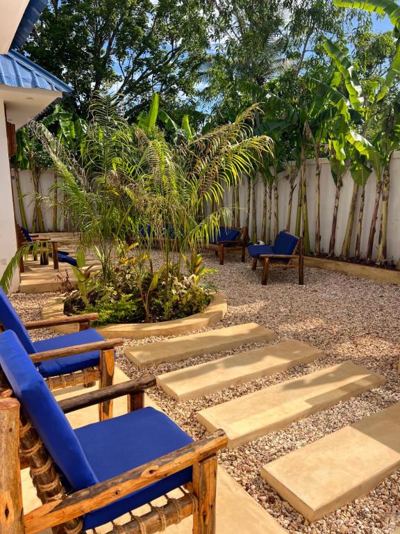 A blue lounger on the paving among palms