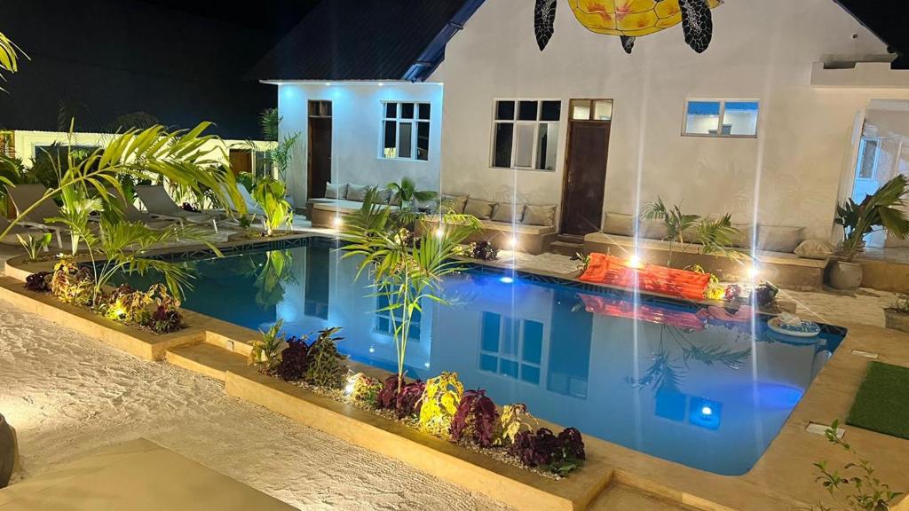 The pool, terrace and guest rooms lit in the evening