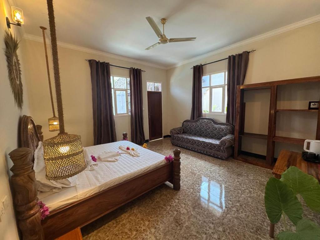 A guest room with a bed, shelving and a sofa
