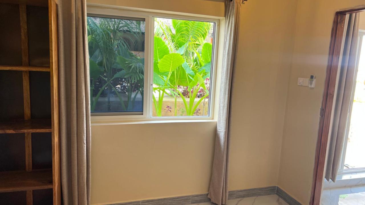 A window looking out onto the green of the garden
