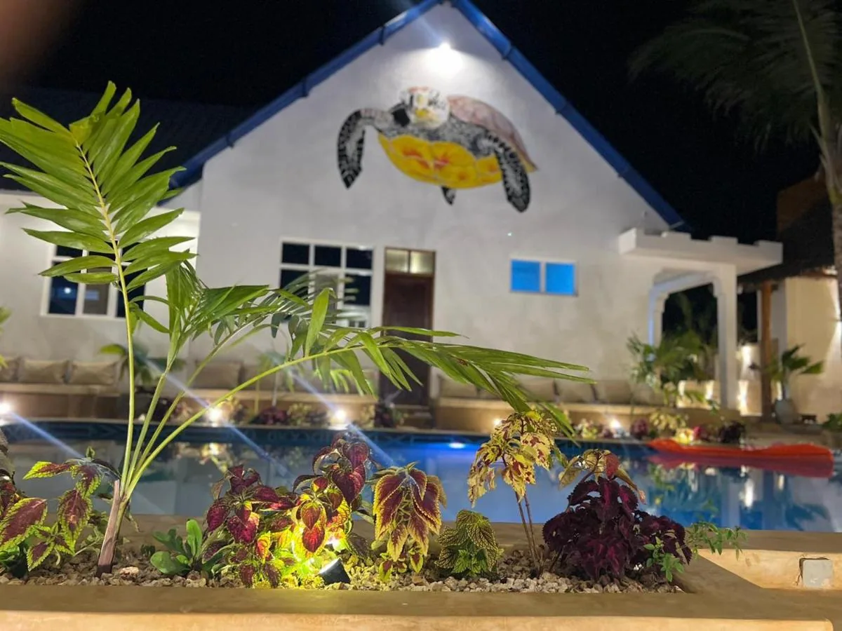 The courtyard at Kendwa Sky Hotel at dusk, with the pool lit from within